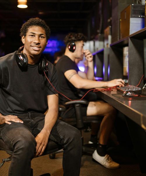 Two gamers playing at a modern gaming station, highlighting technology and e-sports.